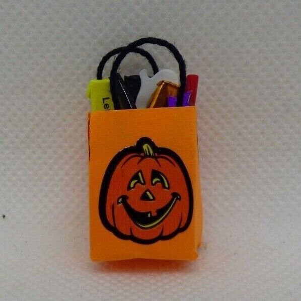 Handcrafted dollhouse miniature trick or treat bag with goodies